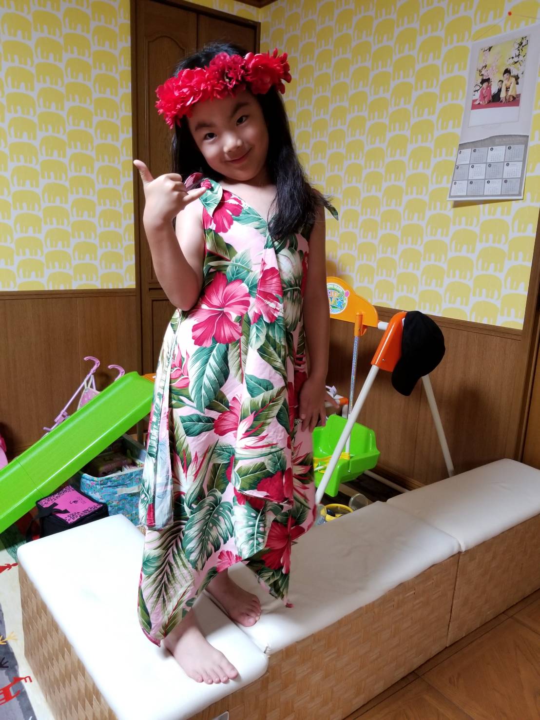 A kid wearing a floral dress