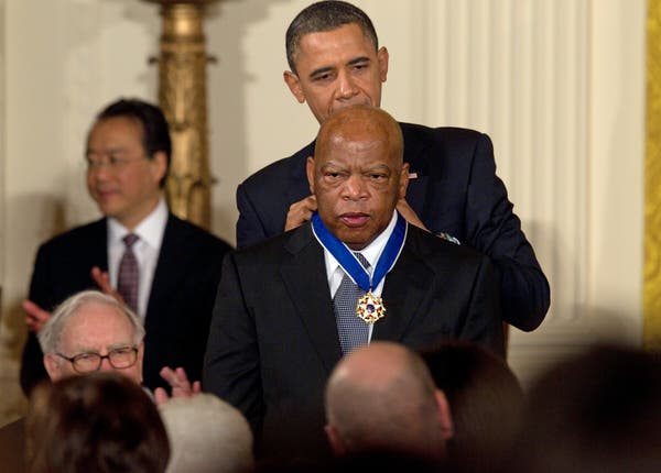 President Barack Obama presenting John Lewis an award